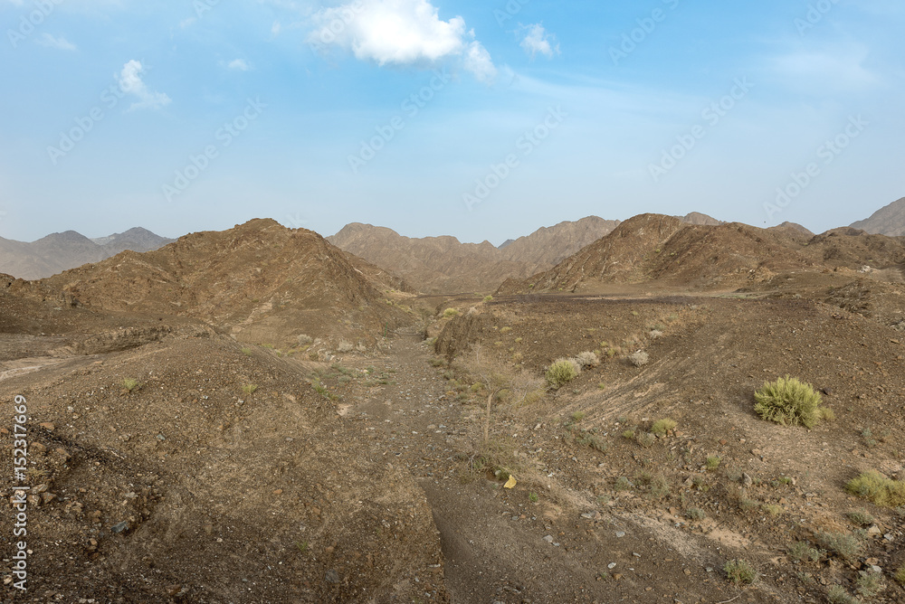 Beautiful View of Wadi in United Arab Emirates with Blue Sky and Clouds. Beautiful View of Wadi in United Arab Emirates with Blue Sky and Clouds.