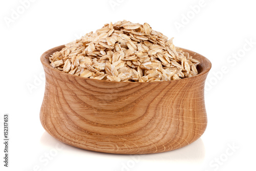 oat flakes in a wooden bowl isolated on white background