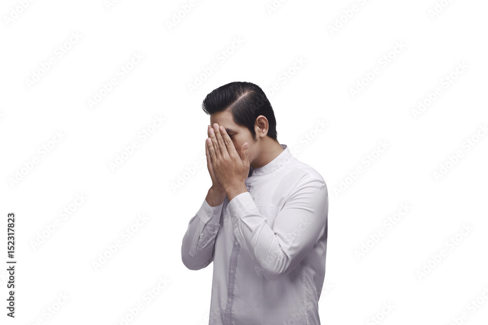 Young asian muslim in traditional dress praying to god Young asian muslim in traditional dress praying to god