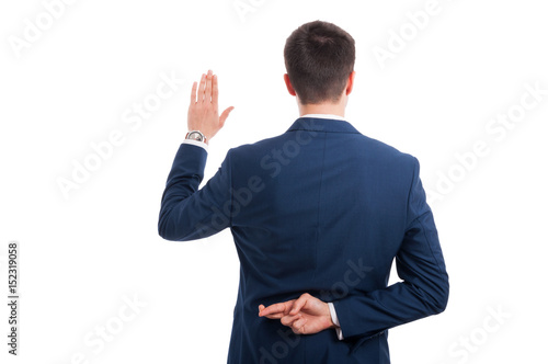 Salesman promising an oath with crossed fingers