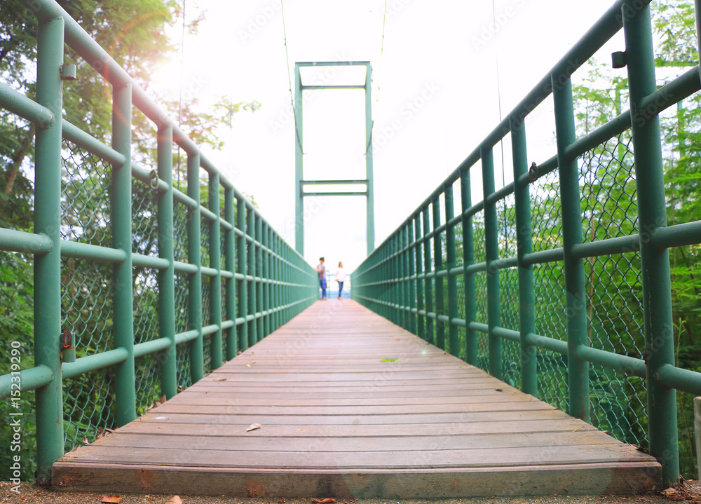 Rope bridge wood floor, Sweetheart on the steel bridge with blurred style Rope bridge wood floor, Sweetheart on the steel bridge with blurred style