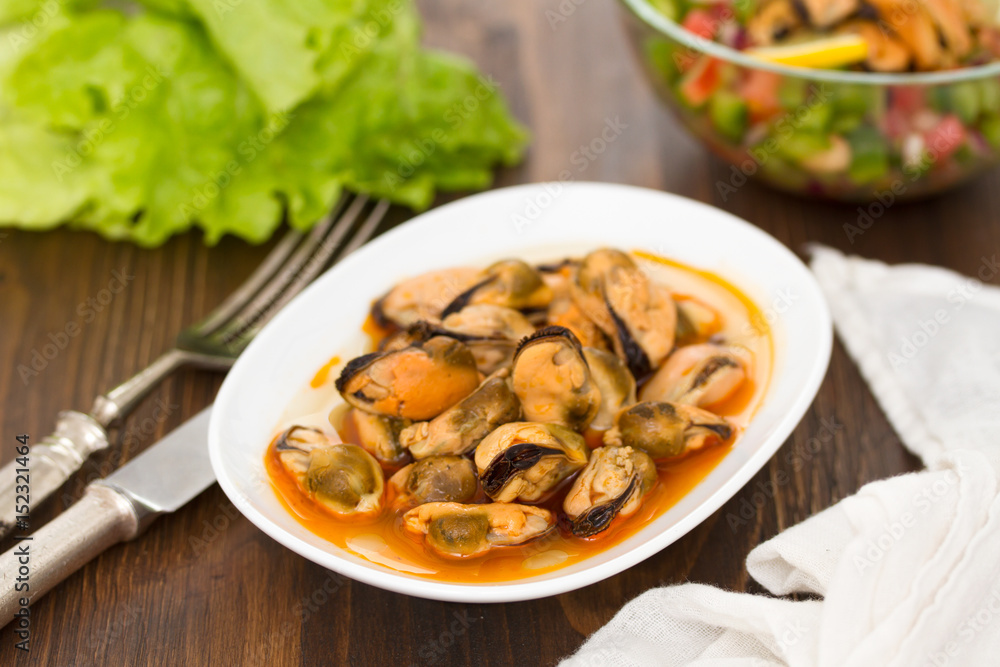 mussels in sauce on white dish