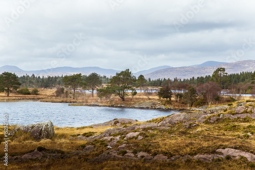 A beautiful irish mountain landscape with a lake in spring. Gleninchaquin park in Ireland.