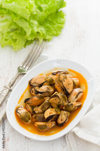 mussels in sauce on white dish