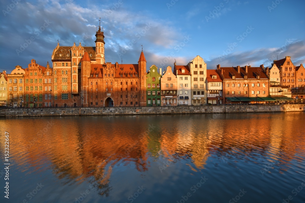 Long Embankment and Motlawa River in the Old Town of Gdansk, Poland at sunrise. Mariacka Gate on the left