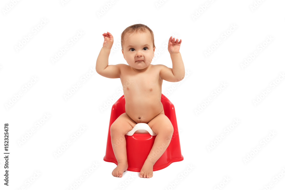 Infant child baby toddler sitting on potty toilet stool pot isolated on a white background Infant child baby toddler sitting on potty toilet stool pot isolated on a white background