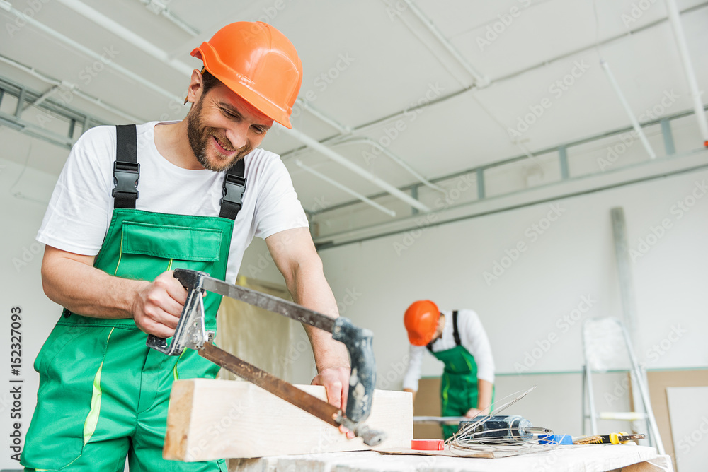 Happy smiling builders making reconstruction Happy smiling builders making reconstruction