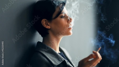 Beautiful fashionable woman smoking a cigarette