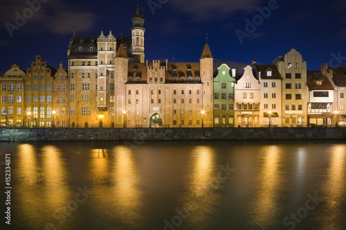 Long Embankment and Motlawa River in the Old Town of Gdansk, Poland at night. Mariacka Gate in the center
