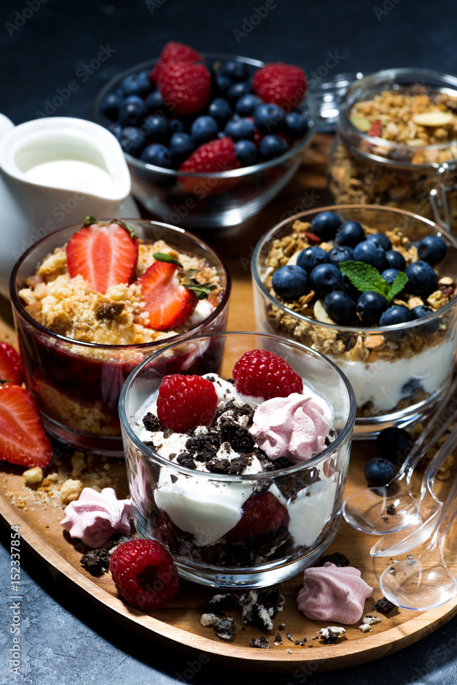 various desserts with berries and cream, vertical top view various desserts with berries and cream, vertical top view