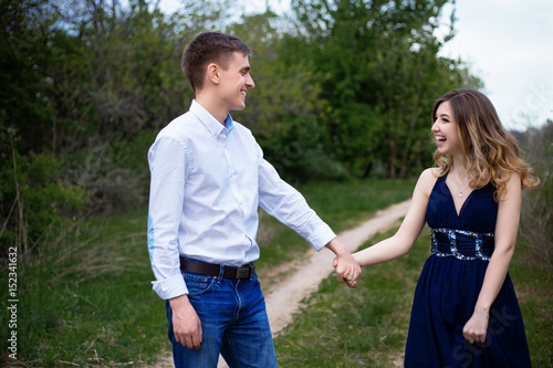 Couple in love walking in the woods holding hands and laughing © Oksana