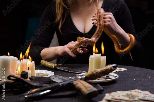 The serpent tempter helps a witch to do the blood rituals of black magic