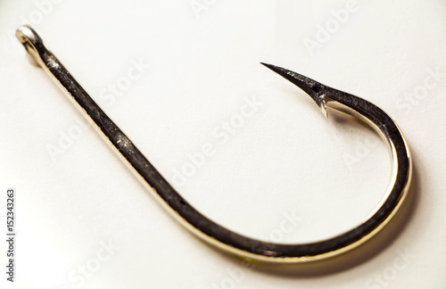 Foto Old rusted fishing hook isolated on a white