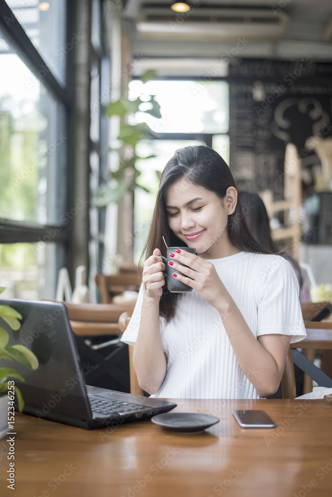 Beautiful business girl working with tablet , smartphone and drinking coffee in coffee shop Beautiful business girl working with tablet , smartphone and drinking coffee in coffee shop