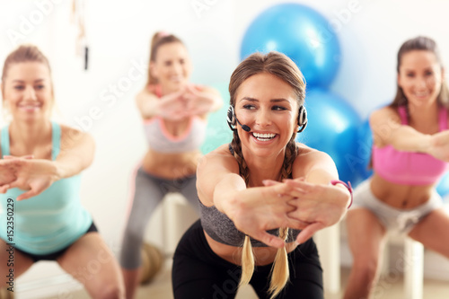 Group of smiling people doing aerobics