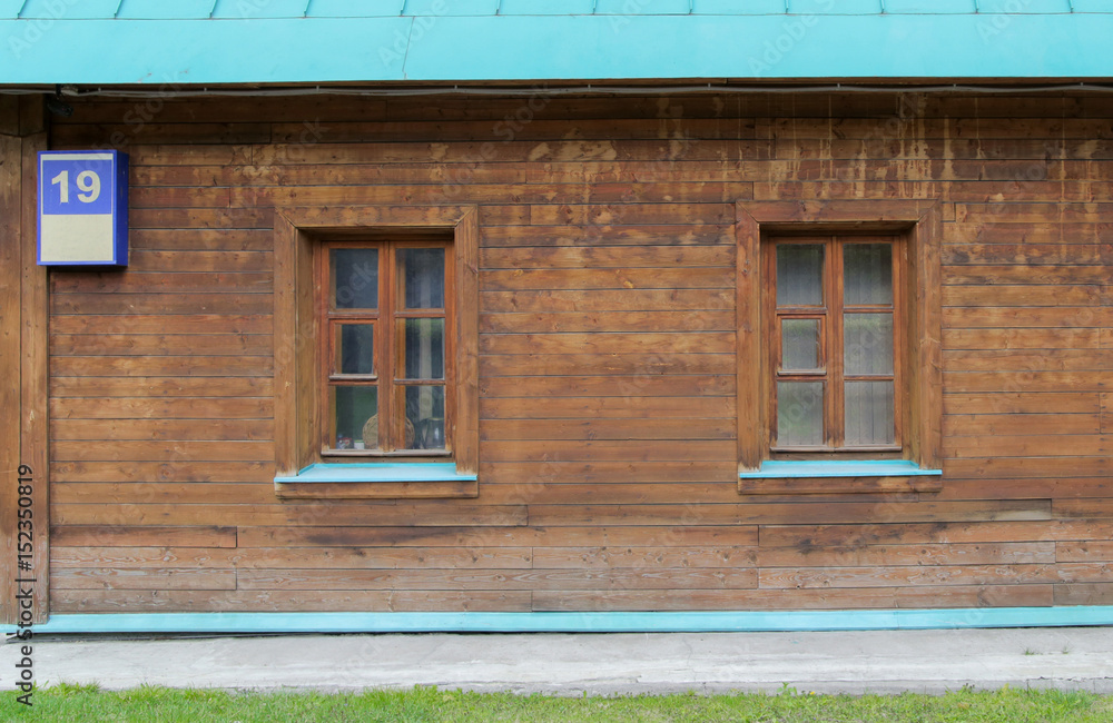 Detail of an old house with unusualy wooden windows Detail of an old house with unusualy wooden windows