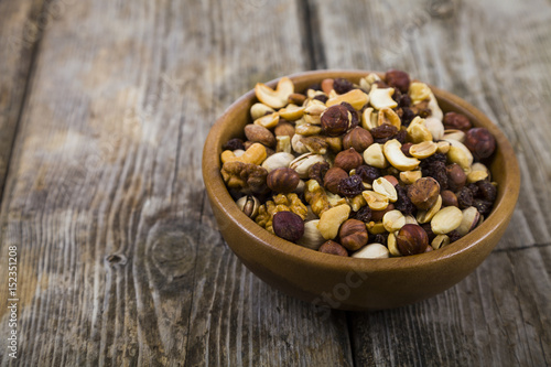 Nuts in a wooden bowl on a wooden table