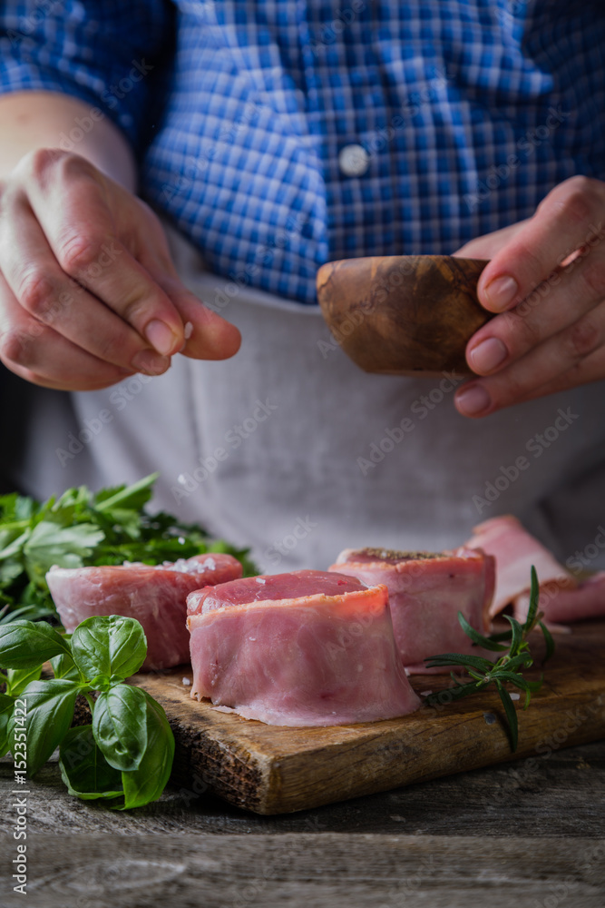 Preparing filet mignon - hands seasoning the steak