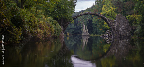 Arch Bridge in Kromlau, Saxony, Germany. Colorful autumn in Germany. Rakotz bridge in Kromlau