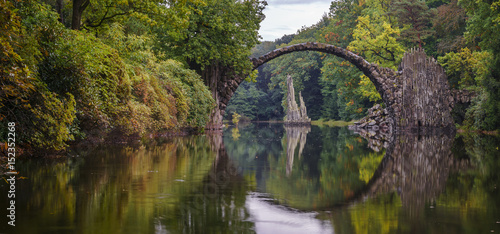 Arch Bridge in Kromlau, Saxony, Germany. Colorful autumn in Germany. Rakotz bridge in Kromlau