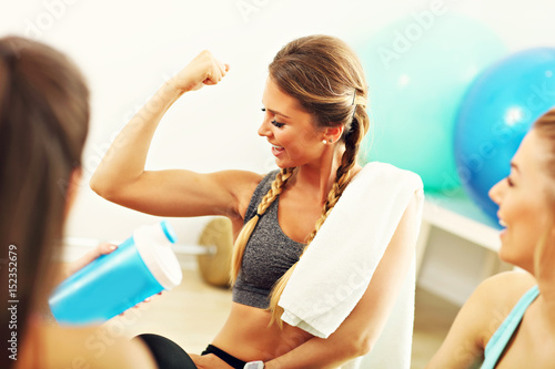 Young women group resting at the gym after workout
