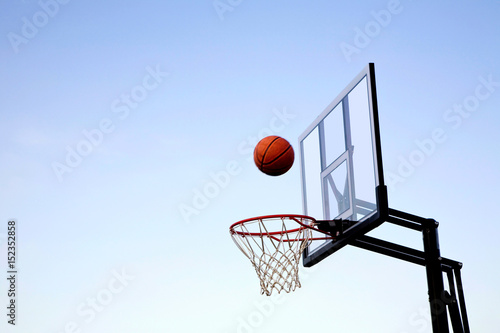 Basketball Midair Going into Hoop © lindahughes