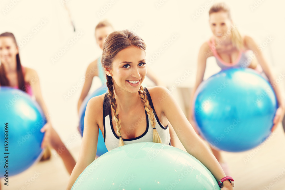 Group of smiling people doing aerobics with balls Group of smiling people doing aerobics with balls