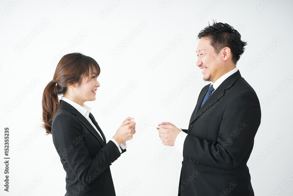 Business persons exchanging business cards