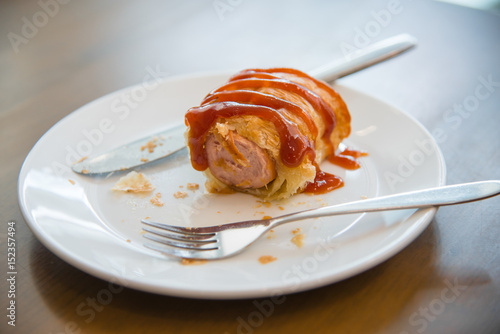 Homemade fresh sausage in the dough close-up photo