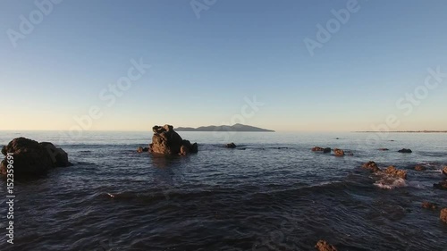 Aerial view of rocky coastline and Kapiti Island in the distance photo