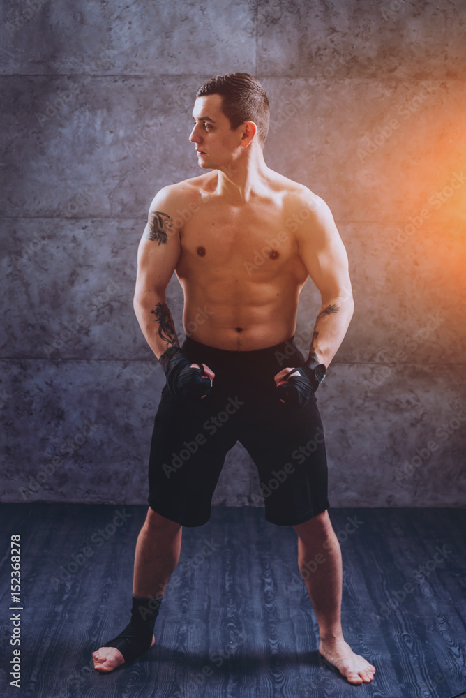 Fototapeta premium Portrait of a street fighter on a gray background.