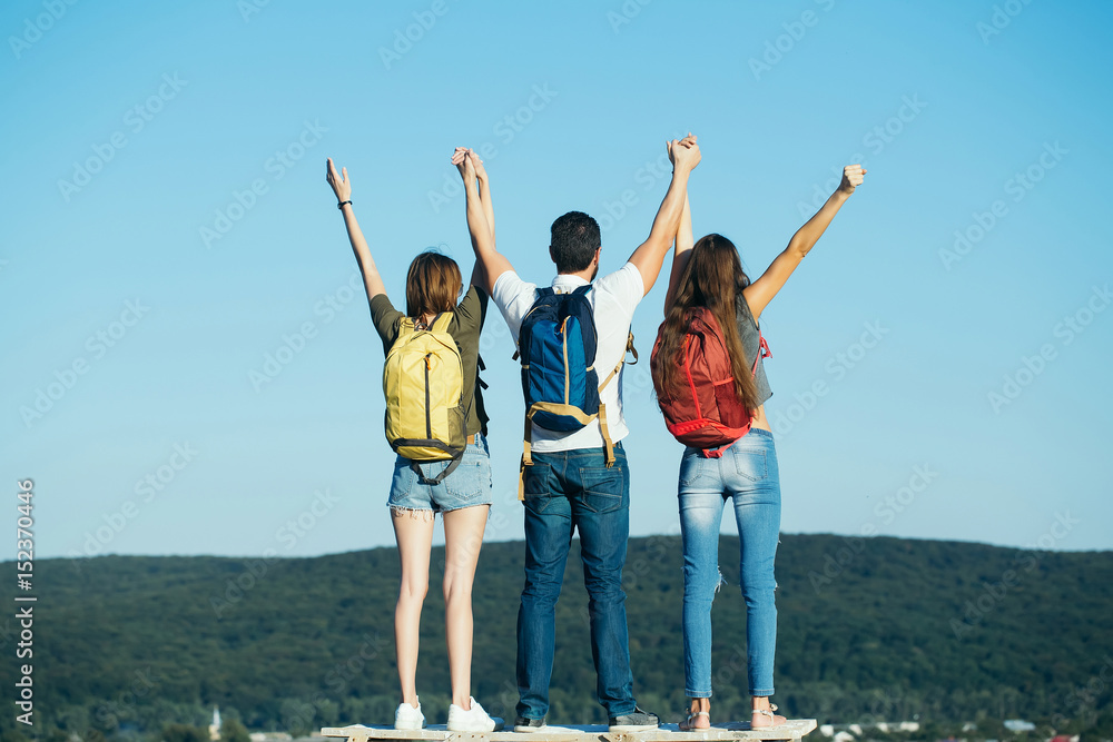 people, girls and man with victory gesture on mountain top people, girls and man with victory gesture on mountain top