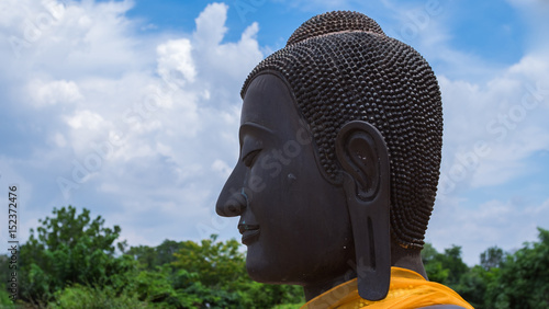 Face of black buddha statute with long ear in ancient temple, Ayuddhaya Thailand photo