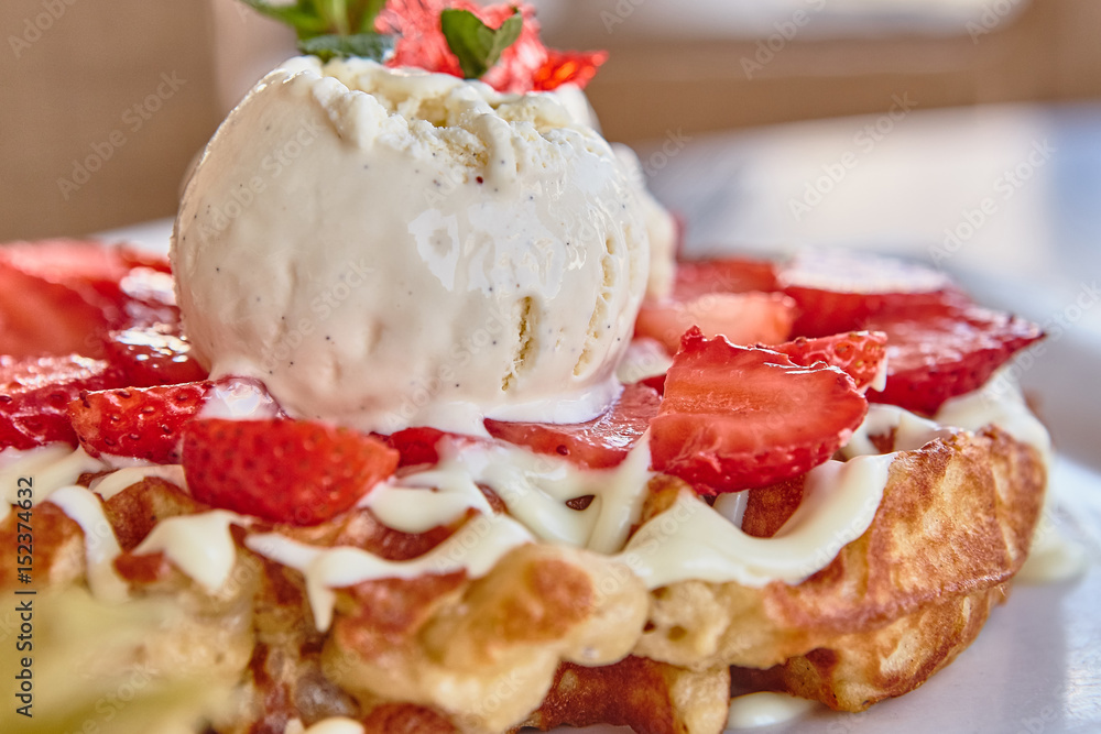 waffles with white chocolate sauce, ice cream and strawberries waffles with white chocolate sauce, ice cream and strawberries