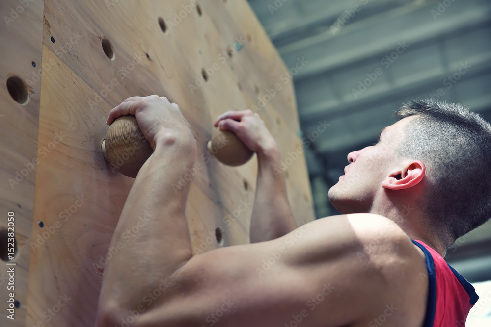 Naklejka premium Climber Man Climbing On Practice Wall