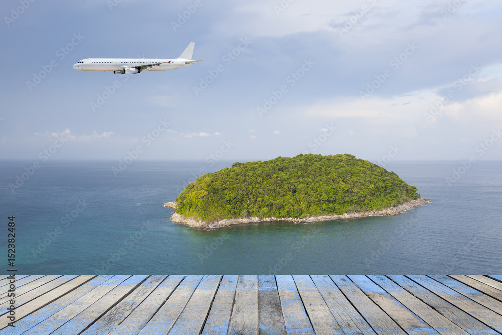 passenger airplane flying over above island tropical sea in phuket thailand, concept open travel season.