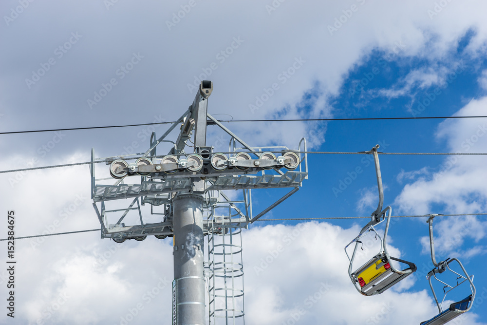 Empty ski lift against beautiful blue cloudy sky Empty ski lift against beautiful blue cloudy sky