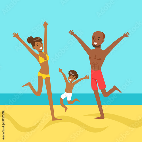 Happy mother and father with their son jumping together on a beach