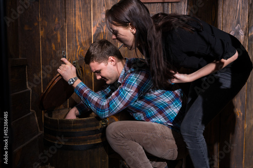 Obraz na płótnie Male and female opened a barrel and trying to solve a conundrum to get out of the trap w salonie