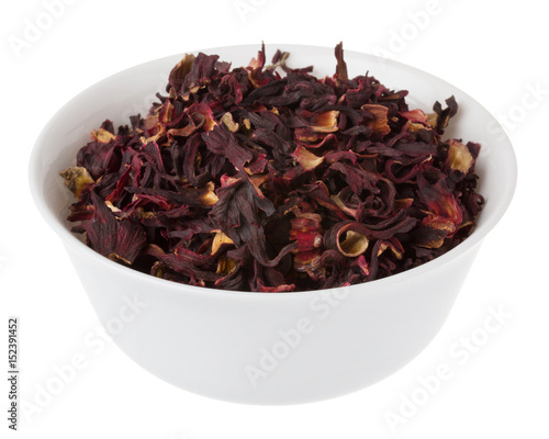 dry hibiscus tea in bowl on white background