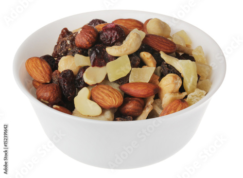 nuts and candied fruits in white bowl on white background isolate