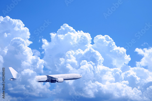 Plane in the blue sky with cloud cover