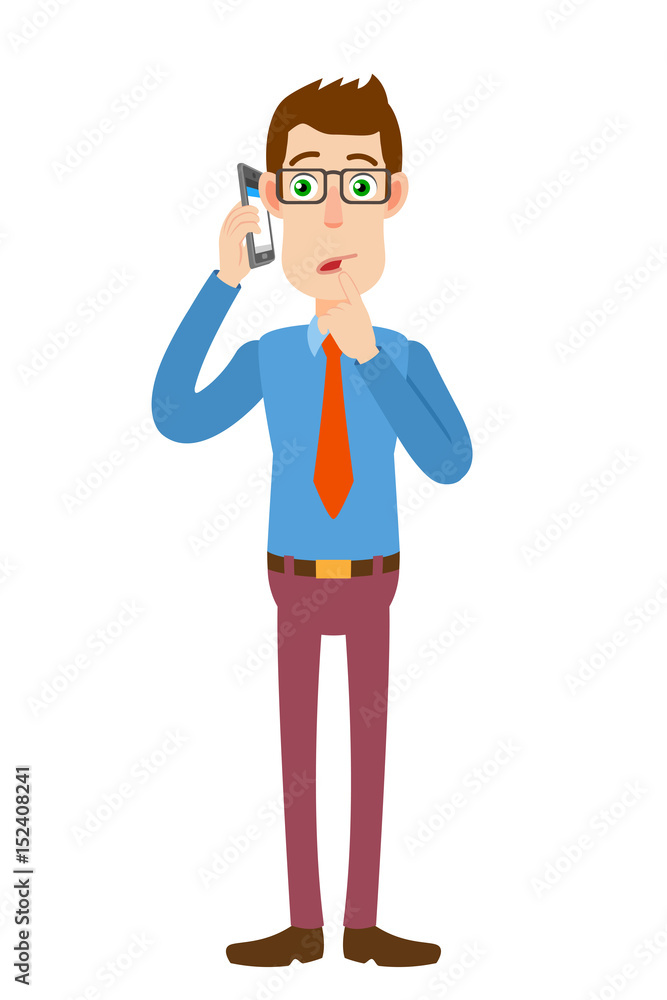 Businessman talking on mobile phone and standing with his finger to his lips