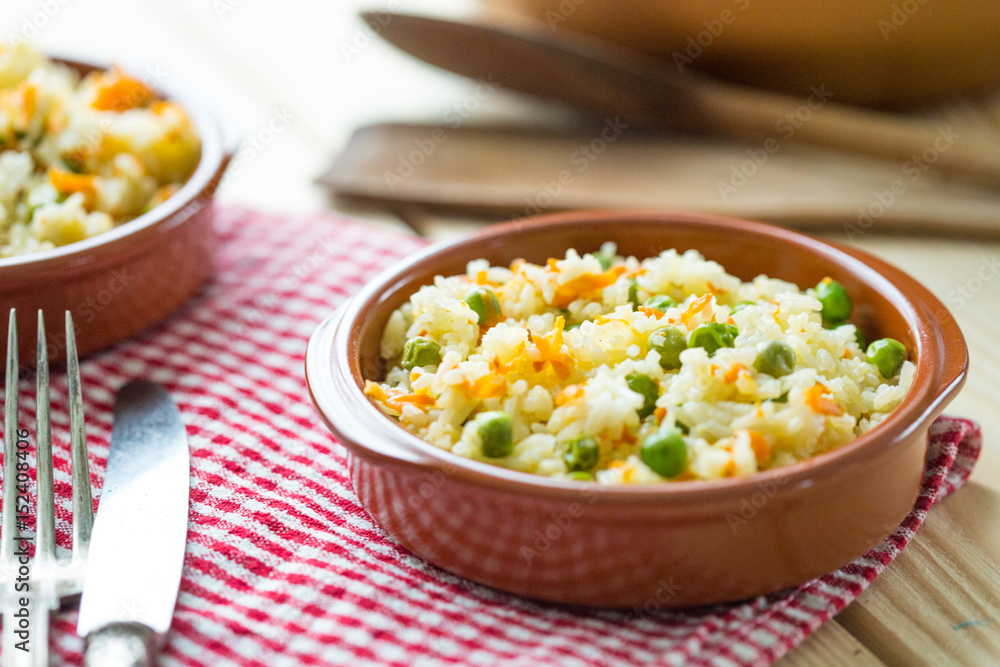 Healthy Rice with Carrot and Peas on Light Wooden Background Healthy Rice with Carrot and Peas on Light Wooden Background