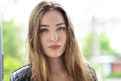 Bild auf Leinwand Young attractive woman standing in the rain directing her face to the drops