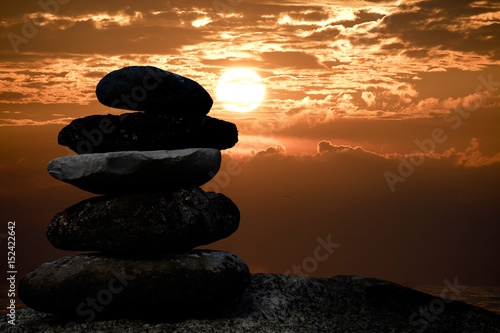 cairn stone silhouette with sunset sky over Lake Michigan
