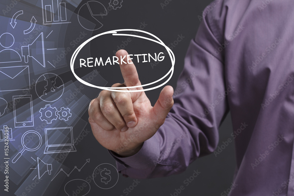 Fototapeta premium Business, Technology, Internet and network concept. Young businessman shows the word: Remarketing