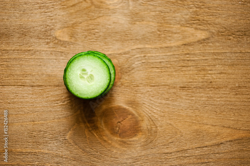 Fresh slice cucumber on wooden background.
