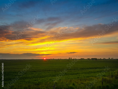 Beautiful evening sunset over green field