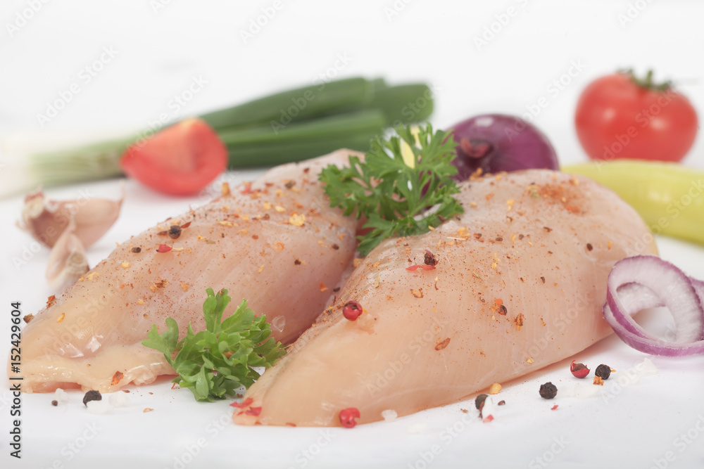 Raw chicken breast with spices and vegetables ready to prepare the meal Raw chicken breast with spices and vegetables ready to prepare the meal